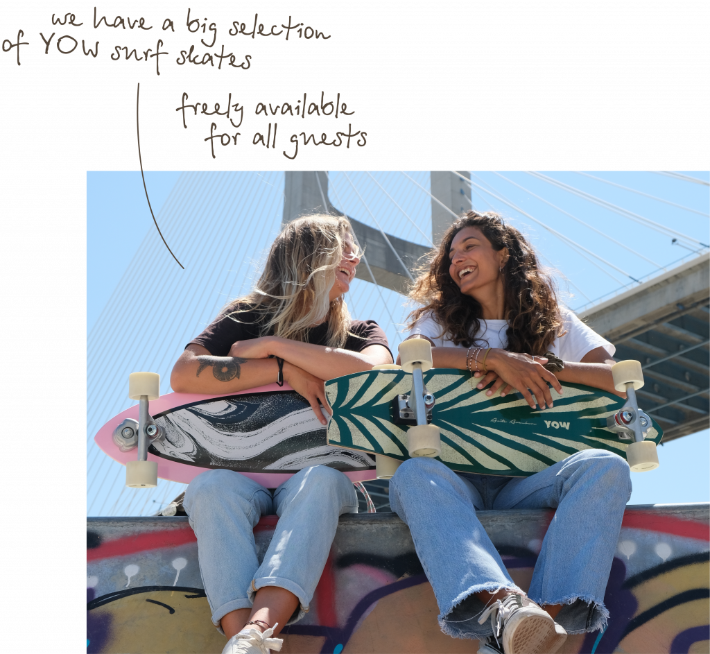 girls laughing at each other, holding surfskates