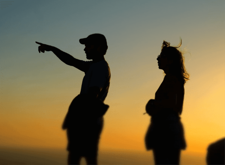 people standing in front of a sunset