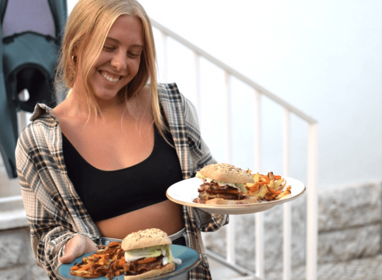 smiling girl with burgers on the plates