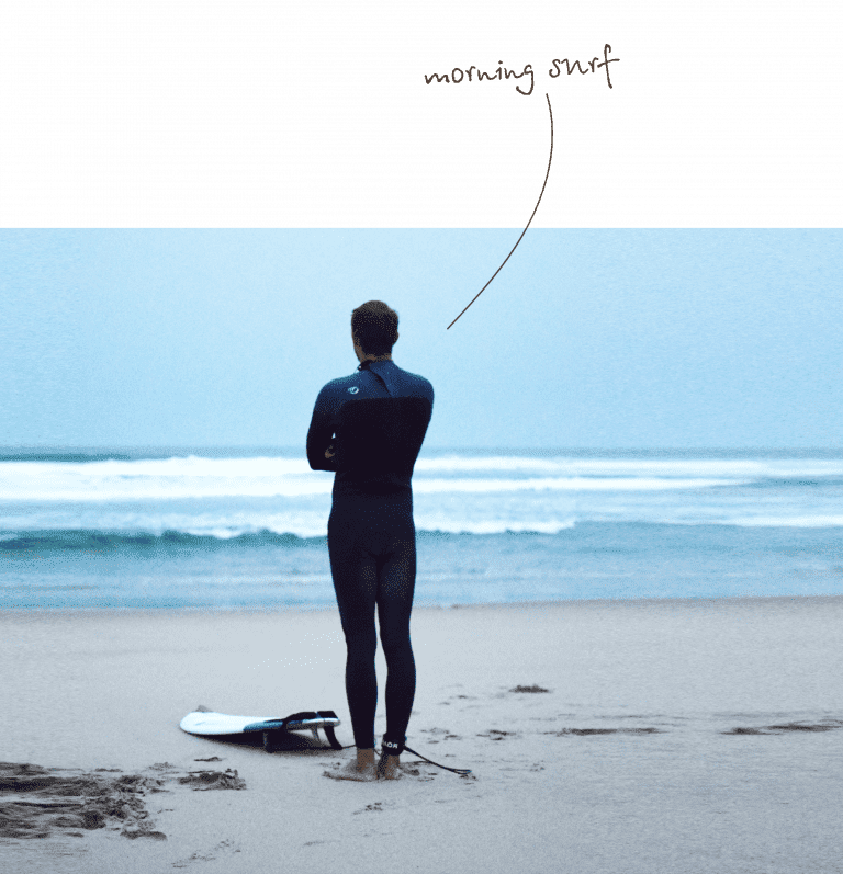 morning surf, man standing in front of the ocean